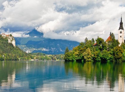 A walk along picturesque Lake Bled affords views of the baroque Church of the Assumption and medieval Bled Castle perched on the cliffs above.