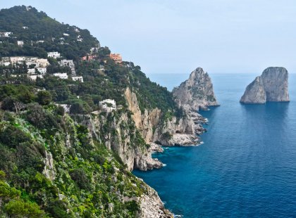 We spend our first full day exploring the rugged Isle of Capri. Hiking trails lead us to spectacular views of turquoise waters and the iconic Faraglioni sea stacks.