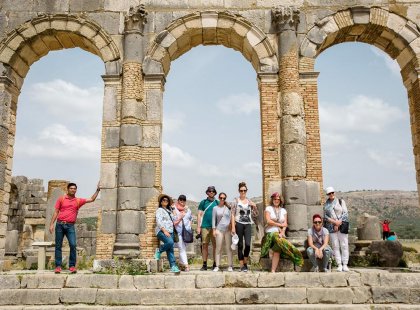 Intrepid Travel group posing under arch, Voulibis ruins, Morocco