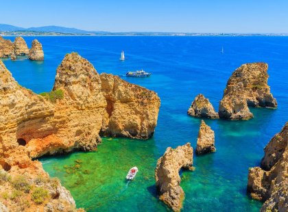 Scenic view of boats between rocks and ocean, The Algarve, Portugal