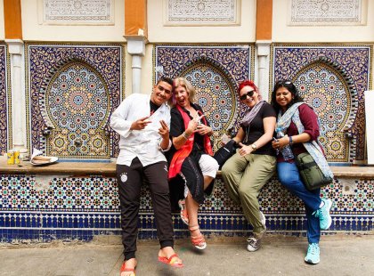 Intrepid Travel group posing in front of mosaic building, Rabat, Morocco