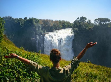 Intrepid Travel Botswana Victoria Falls Botswana women in front waterfall