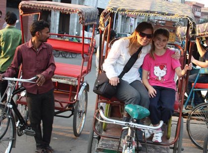 India, mother an daughter rickshaw ride