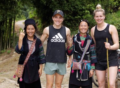 Intrepid travel passengers meeting friendly locals on their hike through Sapa, Vietnam.