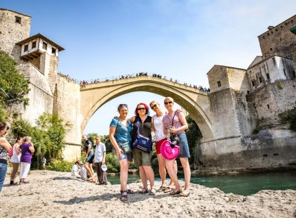Travellers at the famous Stari Most Bridge in Mostar, Bosnia & Herzegovina on an Intrepid Travel tour.