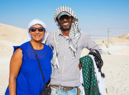 Traveller with local bedouin smiling in desert, Israel & the Palestinian Territories