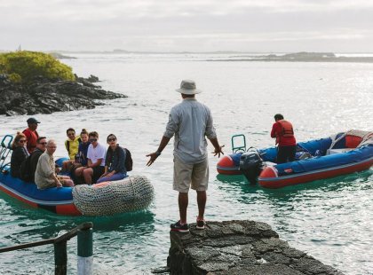 Group travellers and tour leader, panga boat rafts, Galapagos Islands