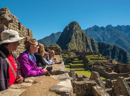 Intrepid travellers and group leader lookout at Machu Picchu, Peru
