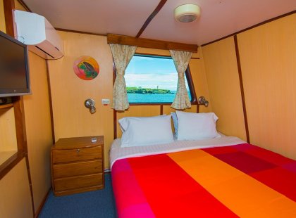 An upper deck double room on Daphne, our Galapagos vessel