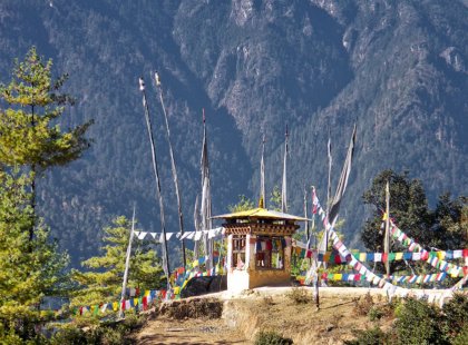 pass by spiritual shrines from which prayer flags flutter in the mountain wind.