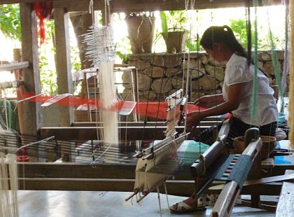 Rich in color and tradition, died cotton, silk and hemp are woven into intricate Laotian textiles.