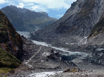 Hike to the massive terminal face of the Fox Glacier, which drops nearly 8,000 feet while carving its way from the Southern Alps down into temperate rainforest.