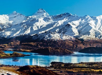 Mount Aspiring looms large above a sea of rugged peaks and hanging glaciers whose meltwater feeds picturesque Lake Wanaka.