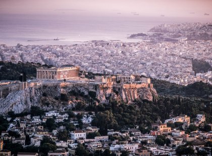 Climb the famous steps up to the ancient ruins of the Acropolis in Athens.