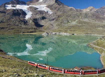 Ride the Bernina Express Train crossing high-mountain passes of the Swiss Alps to reach our hotel in St. Moritz.