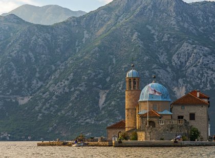 A boat trip brings us to the small island of Our Lady of the Rocks. The church houses an exquisite painted ceiling by 17th-century artist Tripo Kokolja, known by locals as the “Michelangelo of Perast.