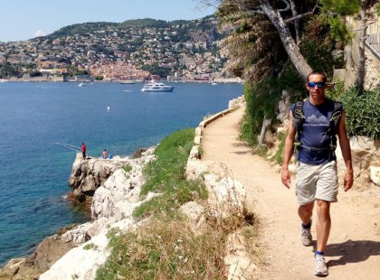 We hike on the peninsula of Cap Ferrat, following coastal trails dotted with lush plants including agaves, prickly pears, maritime pines and tropical flowers.