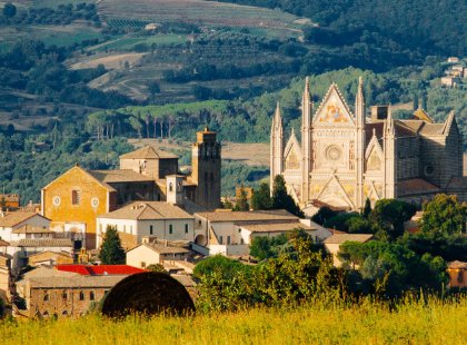Perched on a rock cliff, the façade of the medieval Duomo in Orvieto can be seen from a great distance; the Gothic cathedral with its impressive frescoes took three centuries to complete.