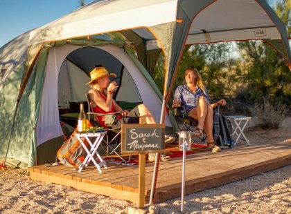Private tent sites feature covered outdoor seating, perfect for relaxing after a big day.