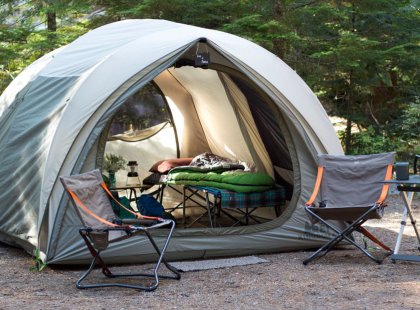 Spacious REI tents and comfortable cots ensure a restful night’s sleep.