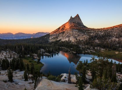 Towering granite peaks and mirror-like alpine lakes punctuate the dramatic landscape of Yosemite's High Country.