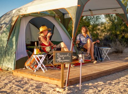 Private tent sites feature covered outdoor seating, perfect for relaxing after a big day.