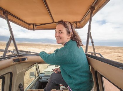 Traveller using the viewing roof during a safari in Ngorongoro National Park, Tanzania on an Intrepid Travel tour
