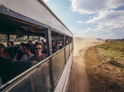 Travellers on a bus through Lake Nakuru National Park on an Intrepid Travel tour