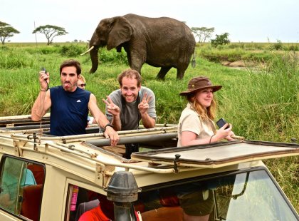 Travellers enjoying their safari in Serengeti National Park, Tanzania on an Intrepid Travel tour