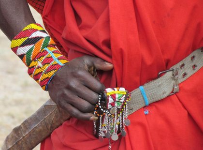 Detailed close up picture of the colourful ordainments of a Maasai tribesperson in Loita Hills, Kenya on an Intrepid Travel tour