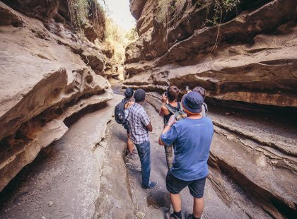 Travellers walking through a canyon in Hells Gate National Park, Naivasha, Kenya