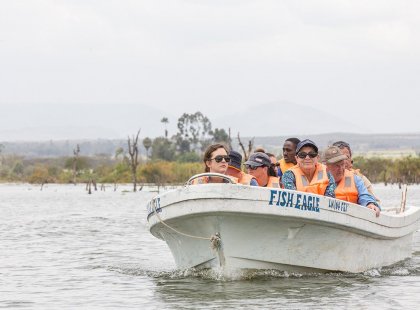 Group of travellers on a boat tour in Lake Naivasha, Kenya as part of an Intrepid Travel tour