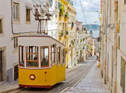 A traditional tram travelling through the streets of Lisbon, Portugal.