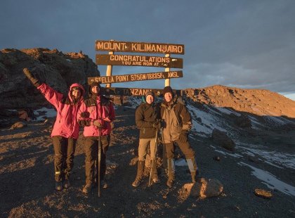 Hikers at the Stellar Point summit sign, Mt Kiliminjaro, Tanzania