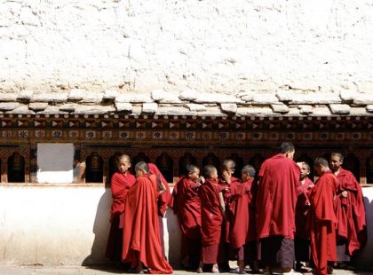 bhutan monks tutor red robes kids school