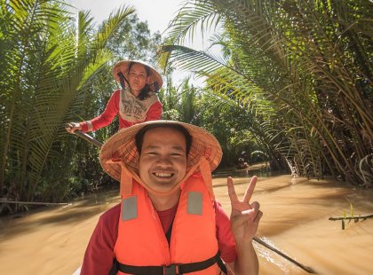 Passenger on a boat ride on the Mekong River, Vietnam on an Intrepid Travel tour.