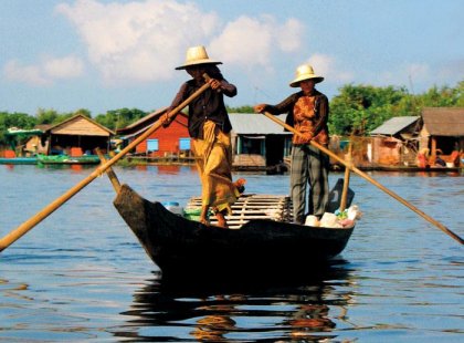 two women rowing boat on mekong river, cambodia
