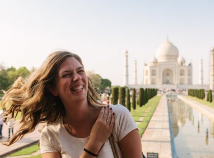 Woman smiling in front of the Taj Mahal on an Intrepid Travel tour of Agra, India.
