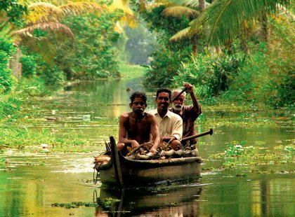 Local men rowing in the backwaters of Kerala, India
