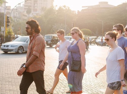 Local group leader taking a travellers on a tour of a city in India.