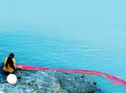 Woman washing Sari in Ganges, India