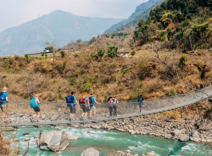 nepal bandipur travellers crossing suspension bridge