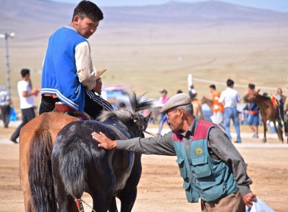 Intrepid Travel mongolia local collecting horse sweat for good luck