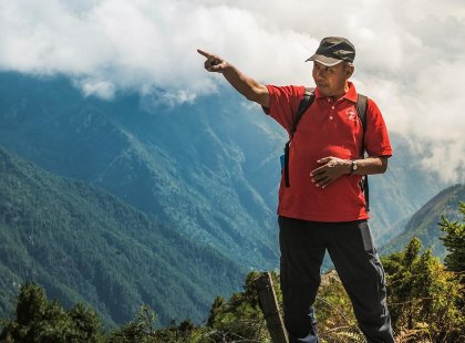 Intrepid Travel local guide pointing the way from Lukla, Nepal