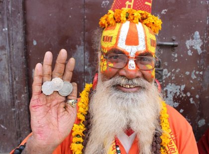 Nepal, Kathmandu, holy man hoding coins