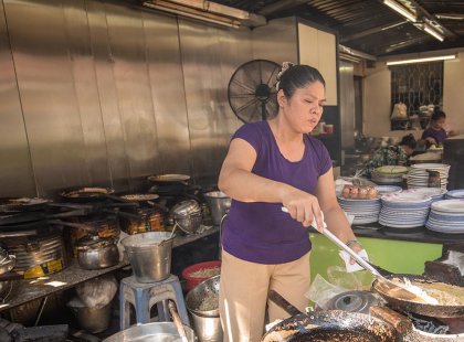 Local cook making food in her shopfront