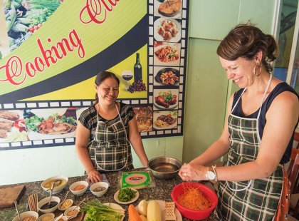 Traveller participating in a cooking class in Hanoi, Vietnam on an Intrepid Travel tour.