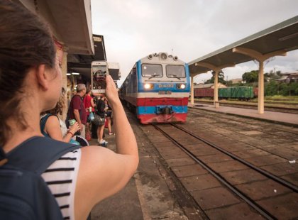 Travellers waiting for the overnight train to depart from Ho Chi Minh City, Vietnam on an Intrepid Travel tour.