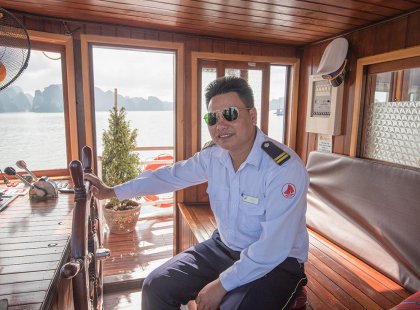 Captain of a boat giving tours within Halong Bay, Vietnam on an Intrepid Travel tour.