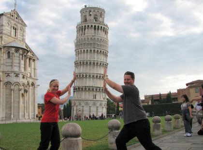 Travellers posing that they are holding up the Tower of Pisa, Italy on an Intrepid Travel tour.